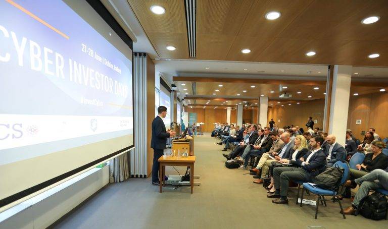 An image of a man speaking in front of an audience at the Cyber Investor Days.