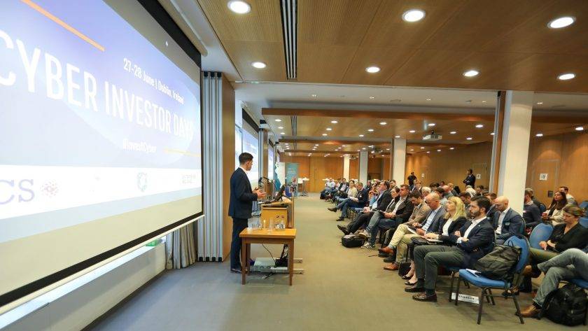 An image of a man speaking in front of an audience at the Cyber Investor Days.