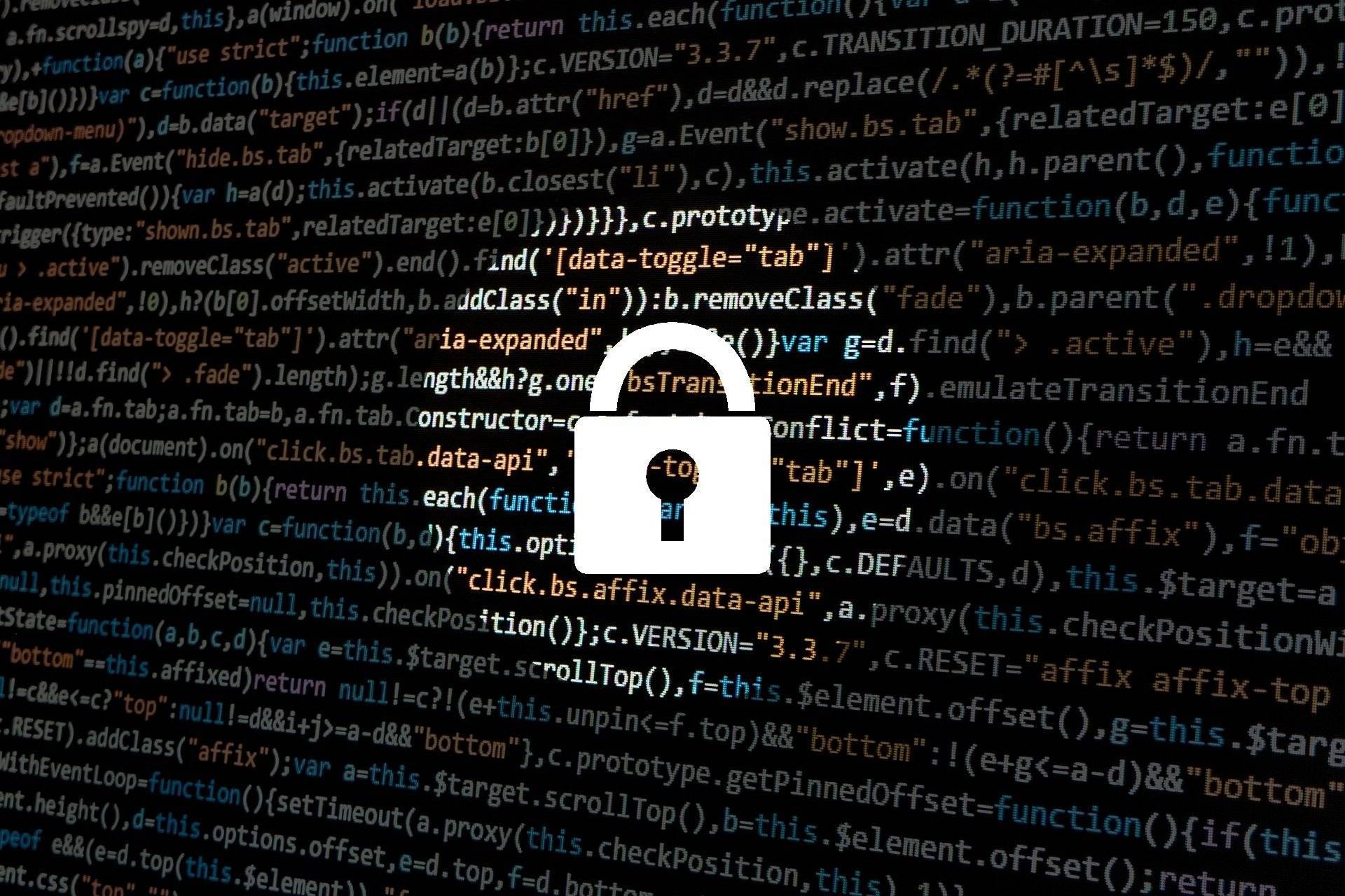 An image of a lock imposed over a screen showing complex coding.