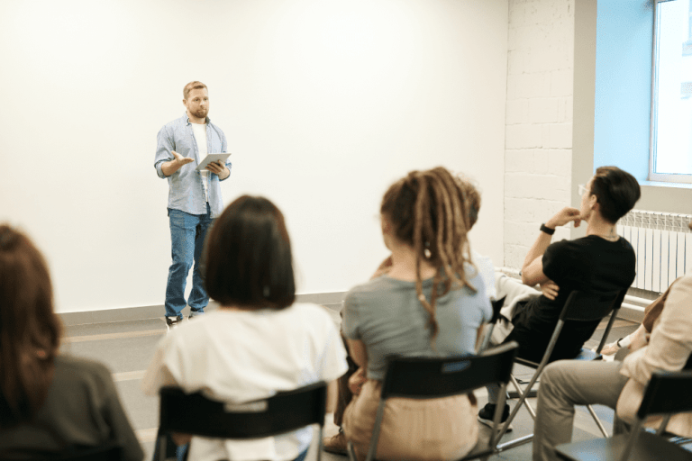 An image of a man talking to an audience.