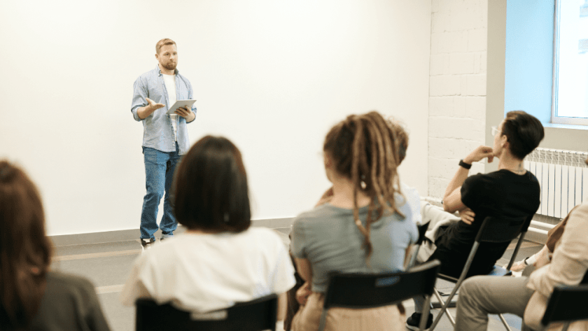 An image of a man talking to an audience.